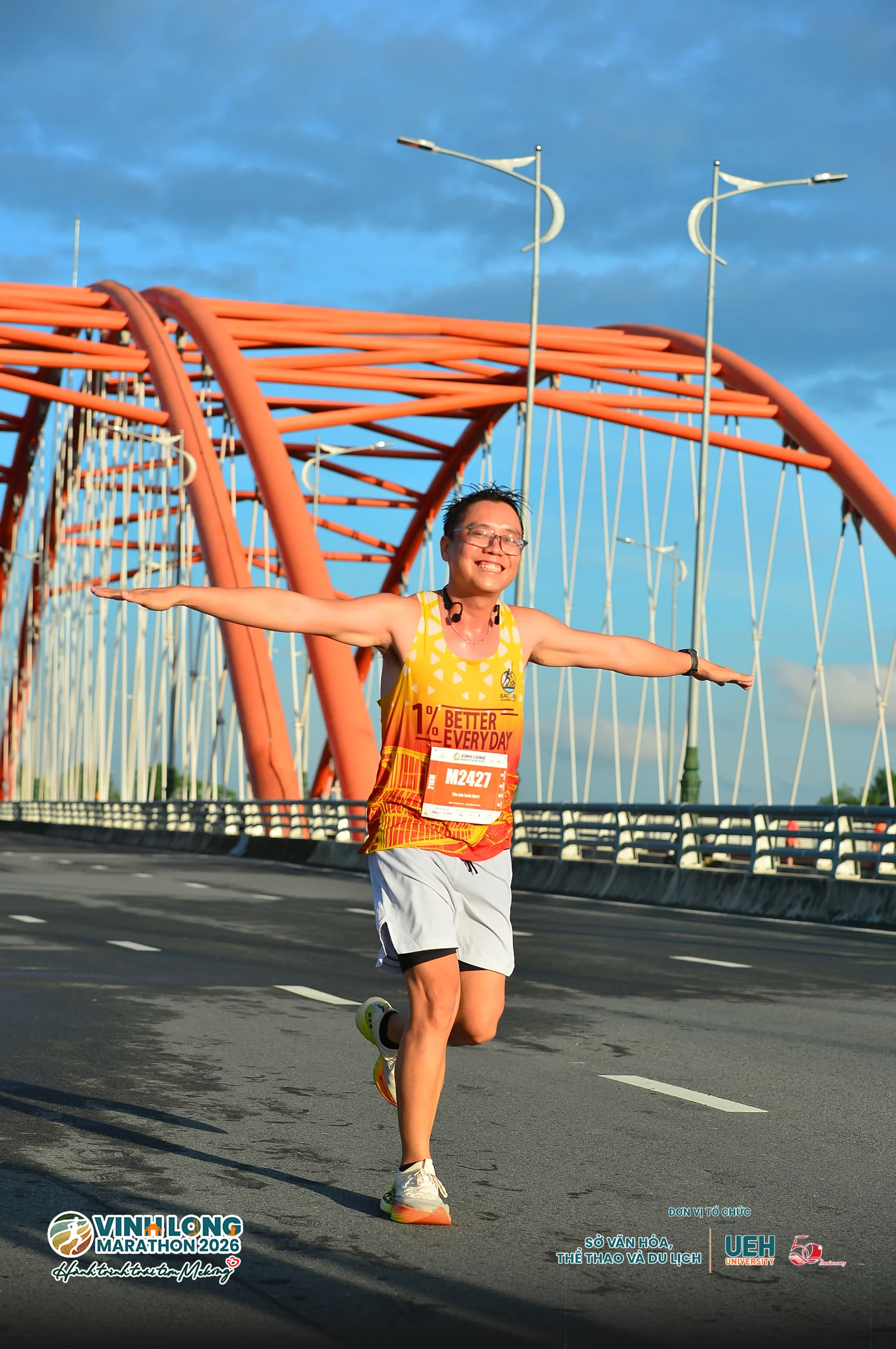 Runner celebrating on the Vinh Long Marathon bridge